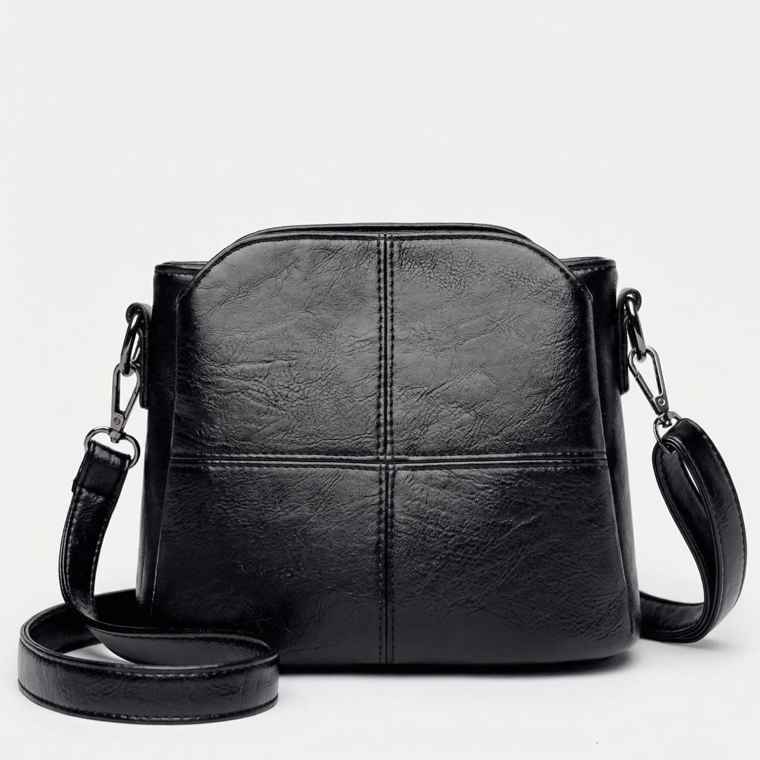 Fashionable green women's daily bag: a compact crossbody shoulder bag with an elegant stitched panel design.
