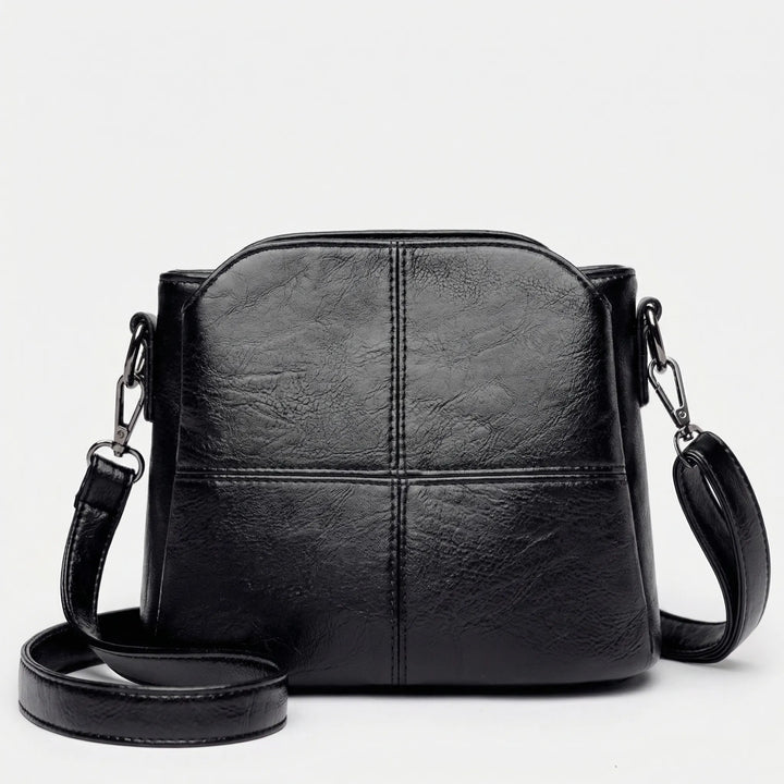 Fashionable green women's daily bag: a compact crossbody shoulder bag with an elegant stitched panel design.
