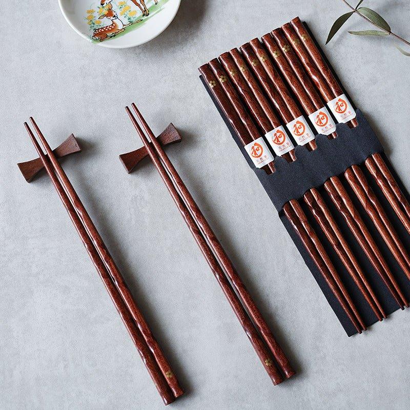 Elegant set of 5 pairs wooden chopsticks with golden cherry blossom design. Perfect Japanese tableware for fine dining.
