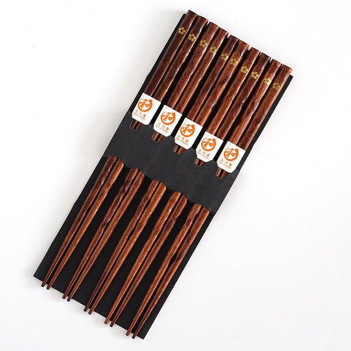 Beautiful wooden chopsticks featuring intricate golden cherry blossom accents, enhancing elegant dining experiences.