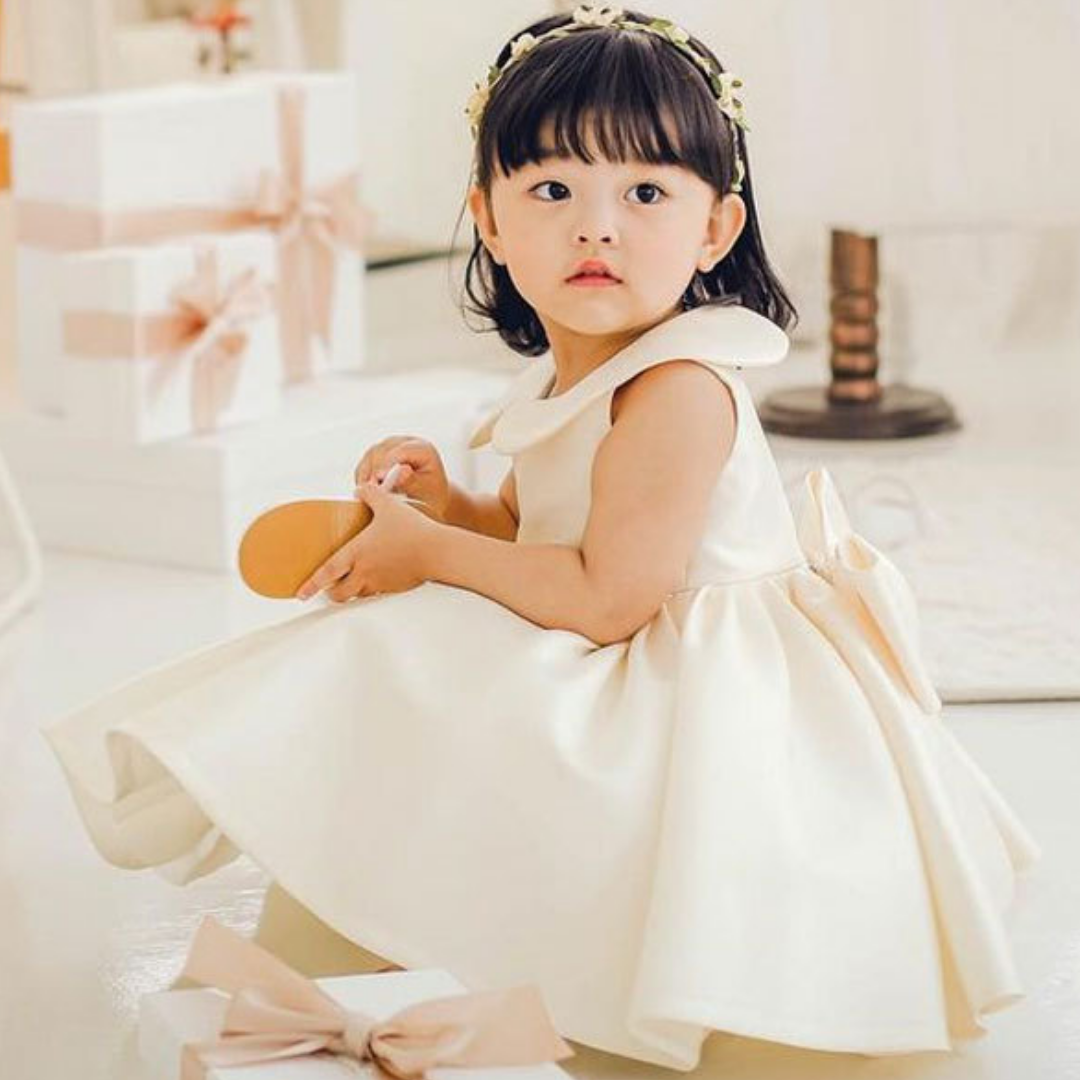 Toddler girl in a vibrant pink sleeveless silk-blend dress with a cute Peter Pan collar