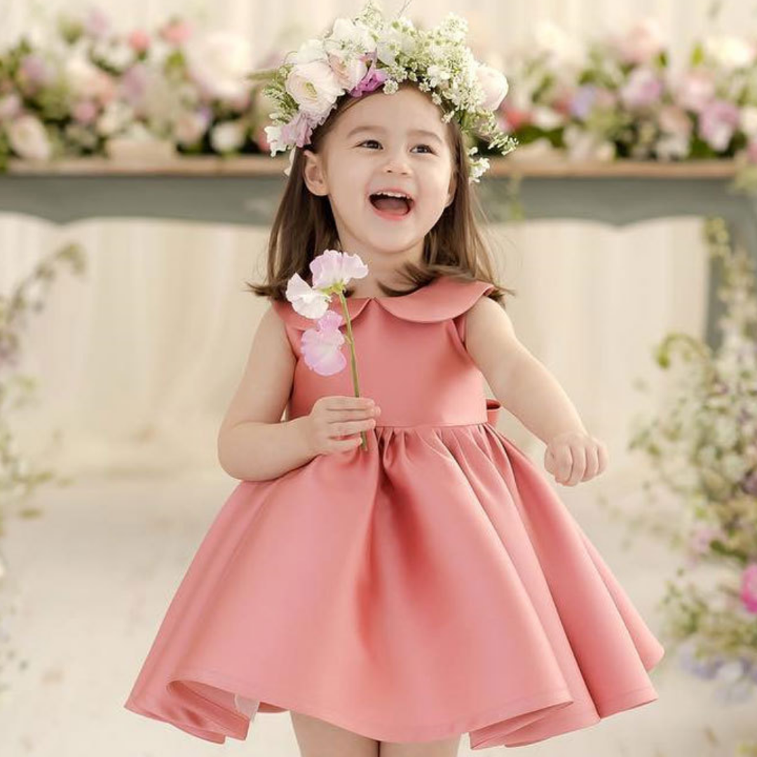 Back view of a girls' elegant fuchsia silk-blend dress, sleeveless with Peter Pan collar