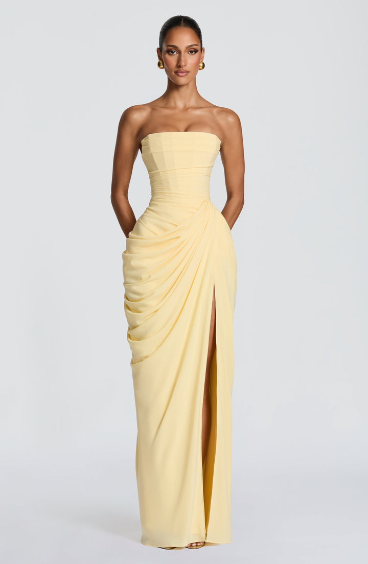 Formal strapless yellow maxi dress, featuring a sculpted corset and a flowing column skirt design.