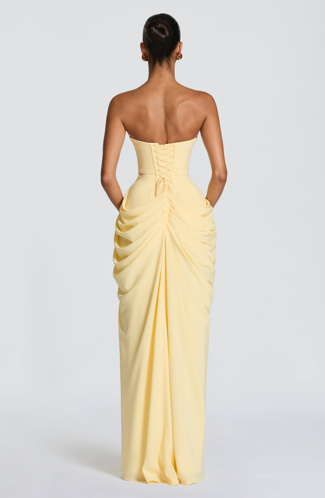 Yellow formal strapless maxi dress for women, with a sculpted corset and an elegant column skirt.