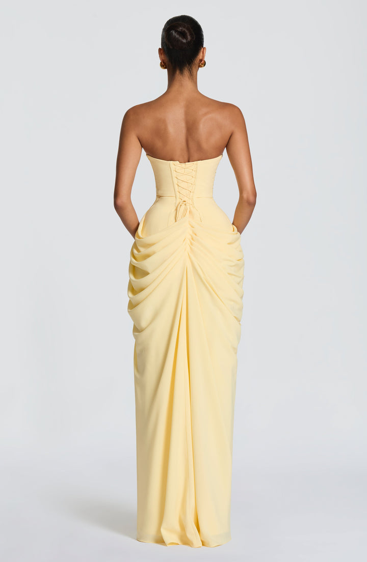 Yellow formal strapless maxi dress for women, with a sculpted corset and an elegant column skirt.