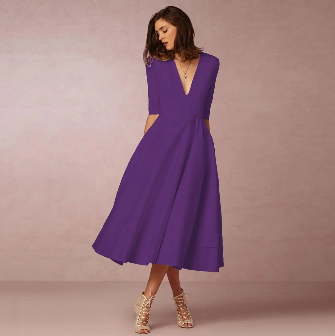 Full body shot of a woman wearing the elegant V-neck elbow-sleeve midi dress.