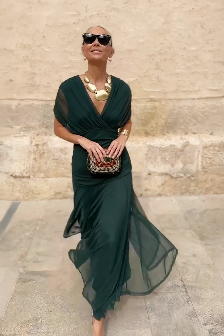 Women's long evening gown with a flattering V-neck and pleated waist, ideal for parties.