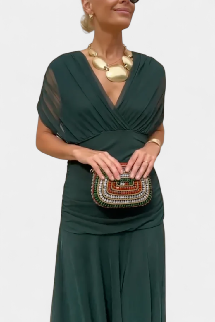 Flattering women's formal maxi dress with pleated waist and V-neck, suitable for elegant occasions.