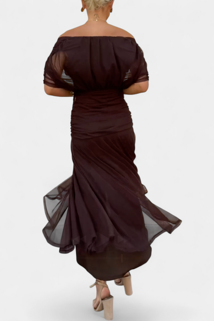 Elegant back of a women's formal maxi dress, floor-length, suitable for wedding guests.