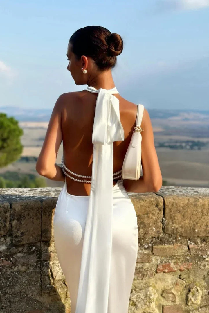 Sophisticated women's halter maxi dress, featuring a backless design. Ideal as an evening gown or special occasion dress.