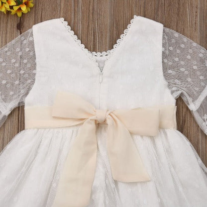 White long sleeve infant dress featuring delicate floral lace, ideal for baby girl fashion.