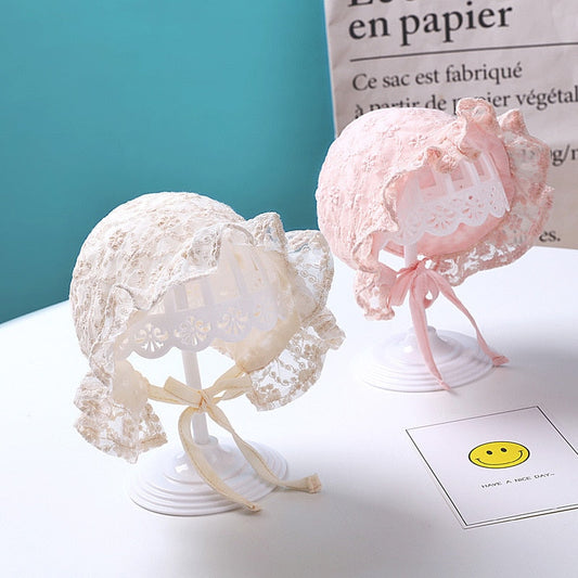 Elegant white lace flower bonnet hat for newborn baby girls, perfect for photoshoots.