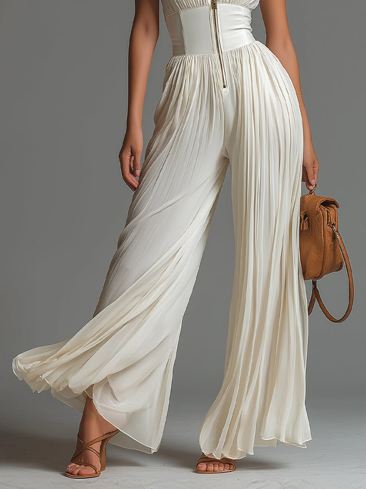 Stunning white pleated jumpsuit for women, featuring a flattering deep V-neck, corset waist, and chic wide leg.