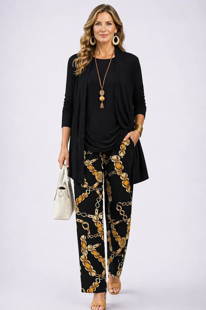 Front view of a woman wearing a complete 3-piece blazer, top, and relaxed trousers outfit.