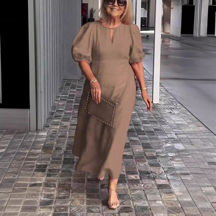 Modern elegant women's midi A-line dress with chic puff sleeves and keyhole detail. Ideal for cocktail & party events.