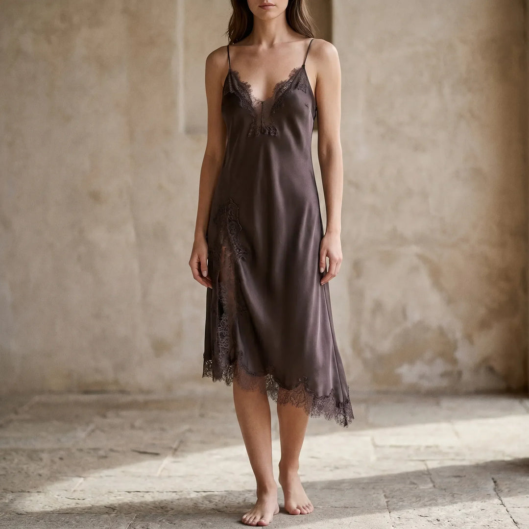 Elegant women's asymmetrical slip midi dress with v-neck, spaghetti straps, and delicate lace trim for evening wear.