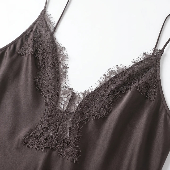 Women's elegant asymmetrical spaghetti strap slip dress with v-neck & lace trim, ideal for summer evening events.