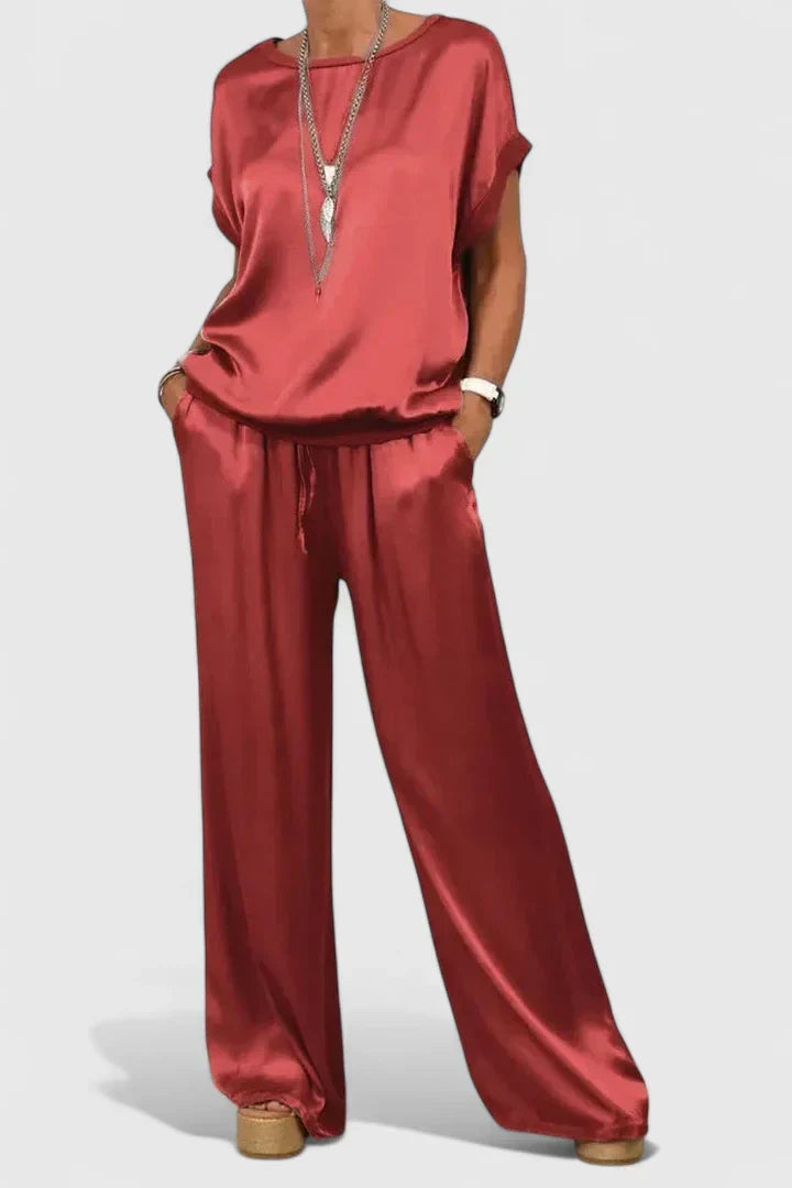 Chic women's batwing sleeve top and high-waisted wide-leg trousers matching set. Elegant & comfortable loungewear.
