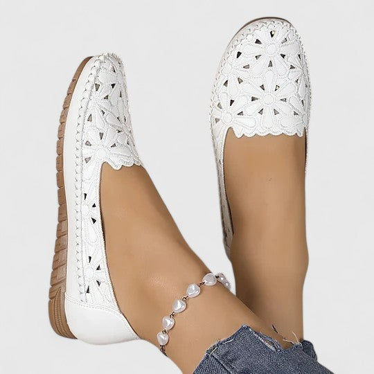 Comfortable women's floral cutout ballet flats, perfect for everyday wear with a cushioned slip-on design.