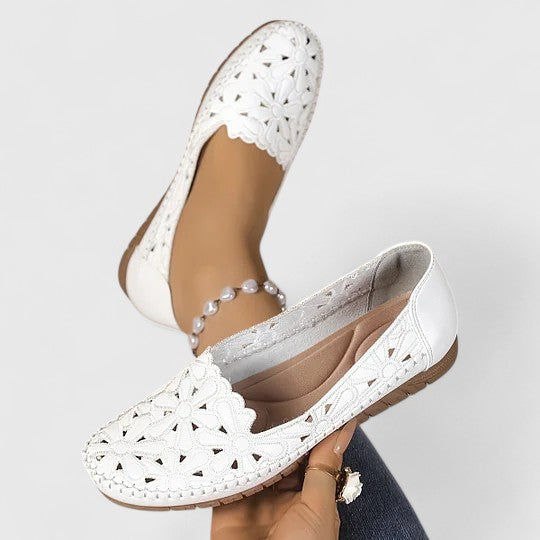 Beige women's slip-on ballet flats with elegant floral cutouts, comfortable for all-day everyday wear.