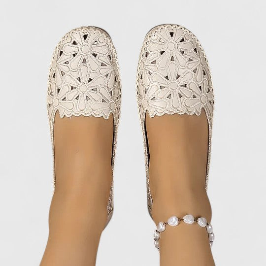 Women's round toe ballet flats with cushioned comfort, featuring chic perforated floral and scalloped details.