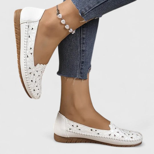 Everyday style women's slip-on ballet flats, featuring perforated floral design for elegant comfort.