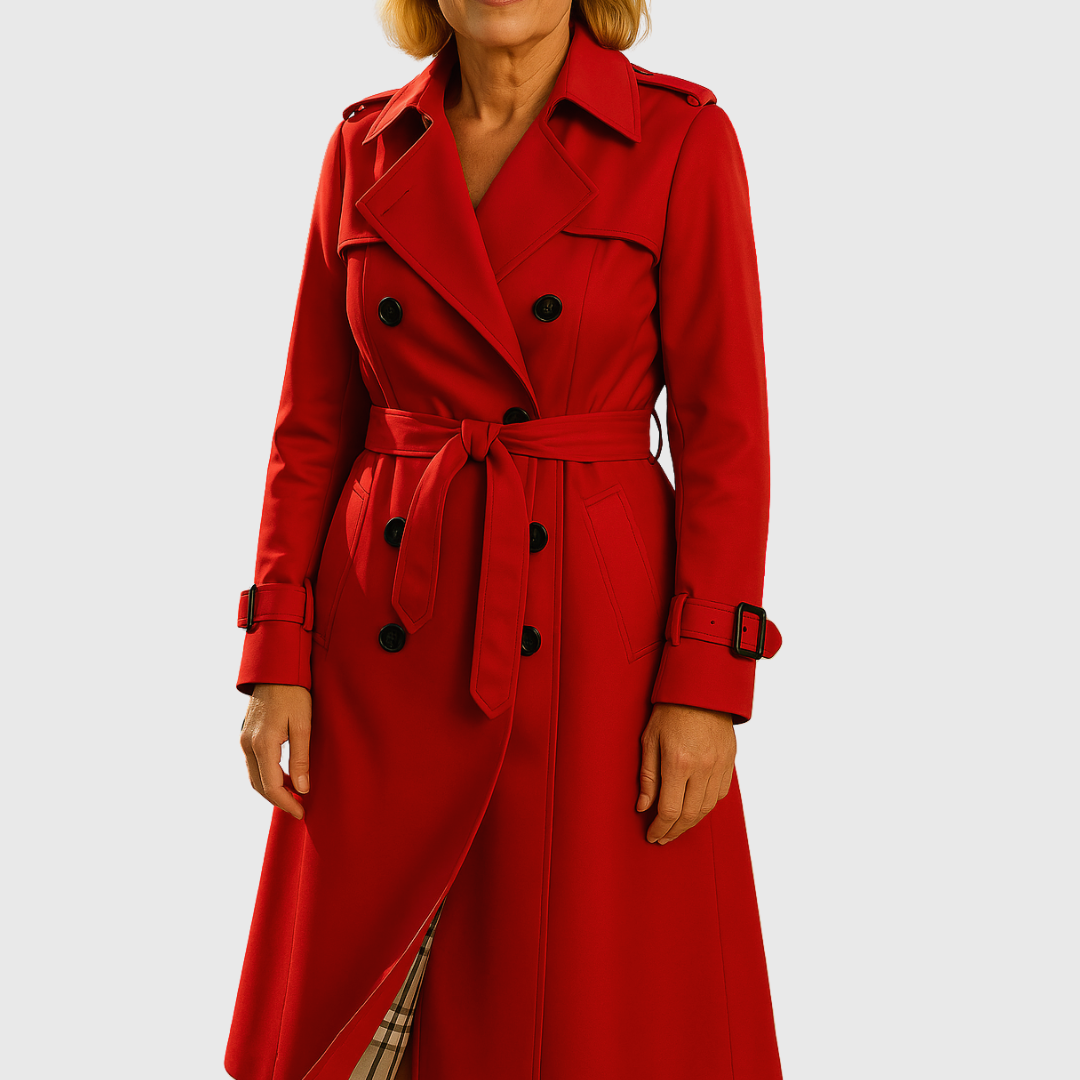 Outdoor shot of a women's water-resistant trench coat, showcasing its double-breasted style and belt.