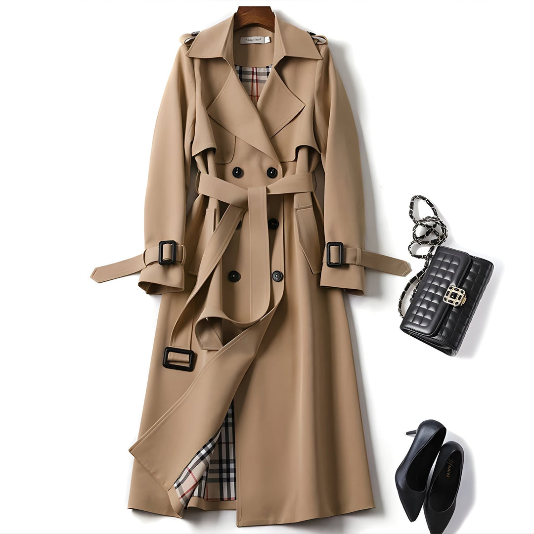 Full-length view of a women's belted double-breasted trench coat. Versatile & water-resistant outerwear.