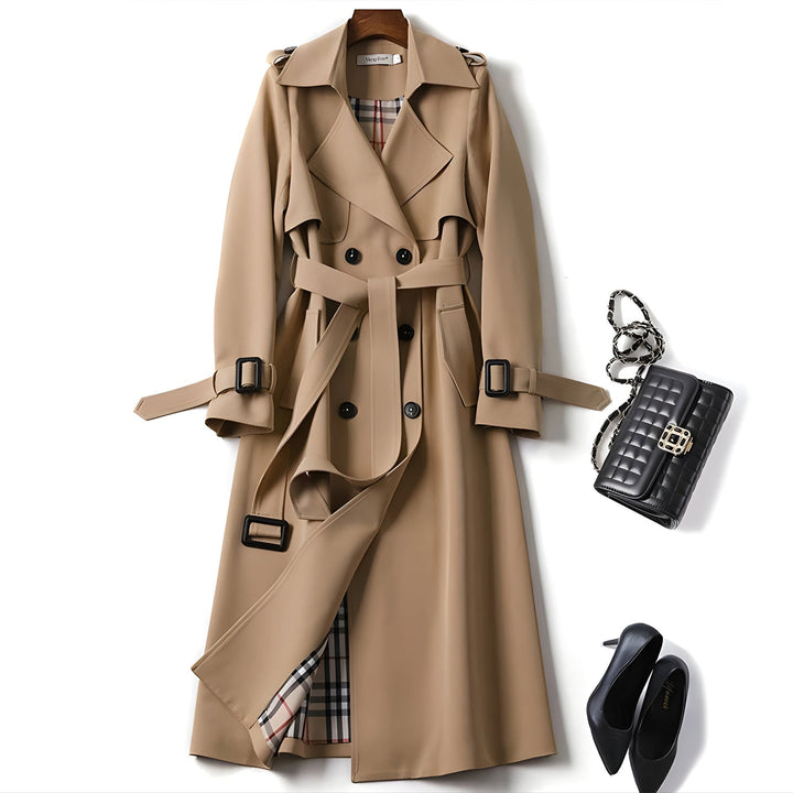 Full-length view of a women's belted double-breasted trench coat. Versatile & water-resistant outerwear.