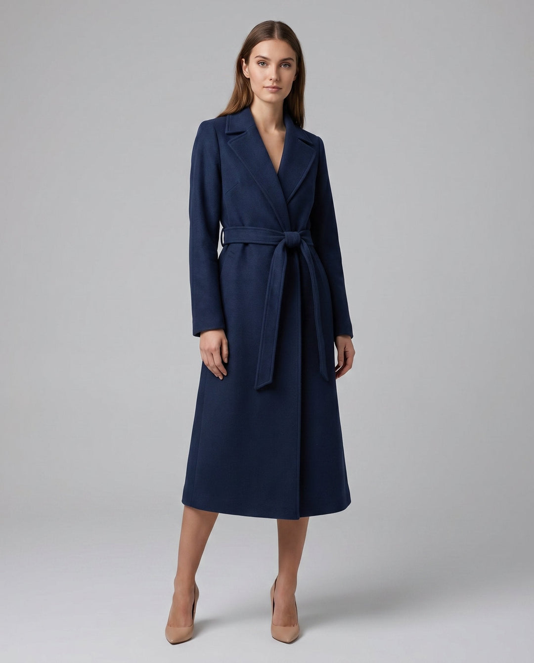 Women's long-line trench coat with belted waist, structured design. Elegant and versatile outerwear for office & evening fashion.