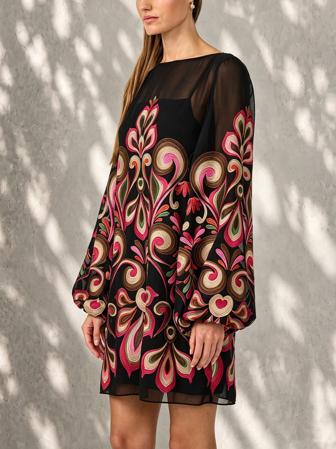 Sophisticated black floral mini cocktail dress. Elegant shift style with balloon sleeves, great for special occasions.