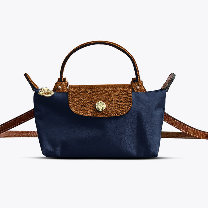 Compact women's mini leather crossbody handbag with an adjustable strap, ideal for daily use & essential items.