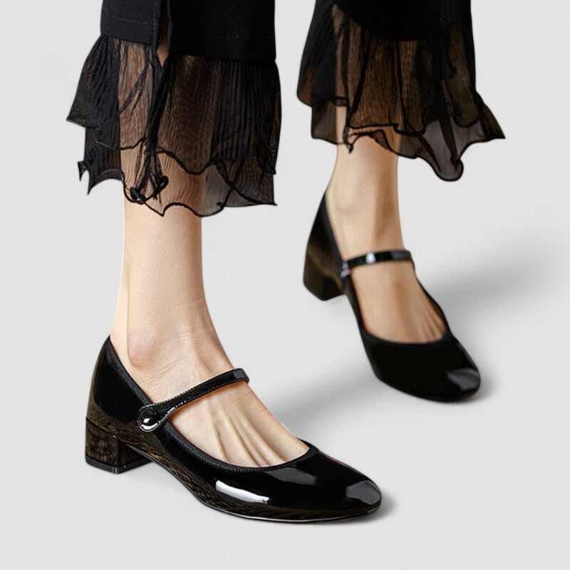 Elegant women's black patent Mary Jane shoes with a comfortable block heel and classic round toe design.