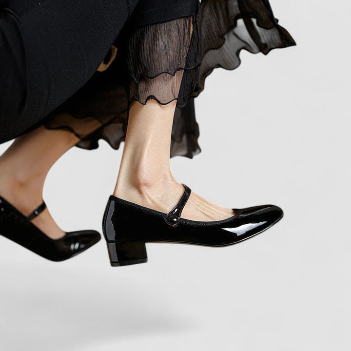 Feminine patent Mary Jane strap shoes with a sturdy block heel and comfortable round toe, ideal for all-day wear.