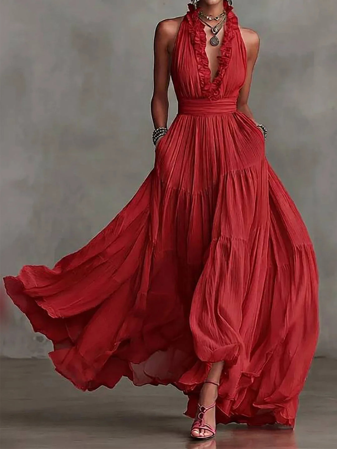 Close-up of the elegant women's maxi dress, showcasing ruffle trim, pleated skirt, and flowing formal fabric.