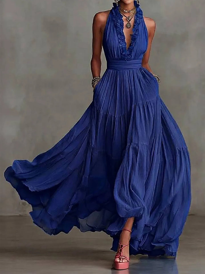 Full-length view of a woman in a chic backless maxi dress, an elegant choice for a wedding guest or party wear.