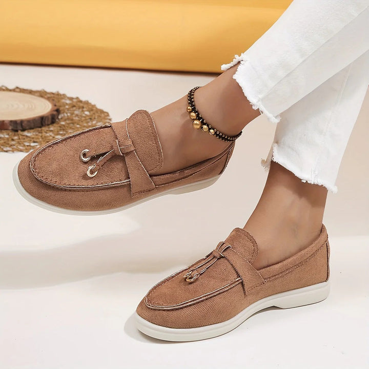 Elegant women's black tassel loafers, perfect for sophisticated style & comfortable all-day wear.