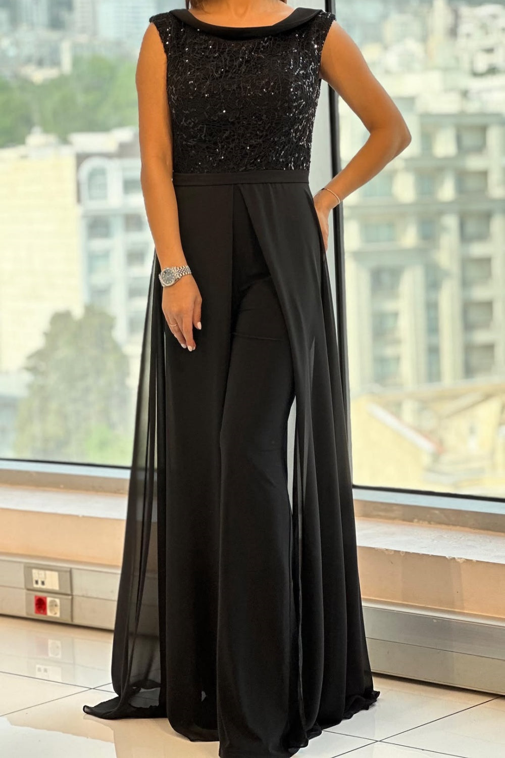 Elegant women's black textured-panel crew neck jumpsuit, versatile for both everyday and special occasions.