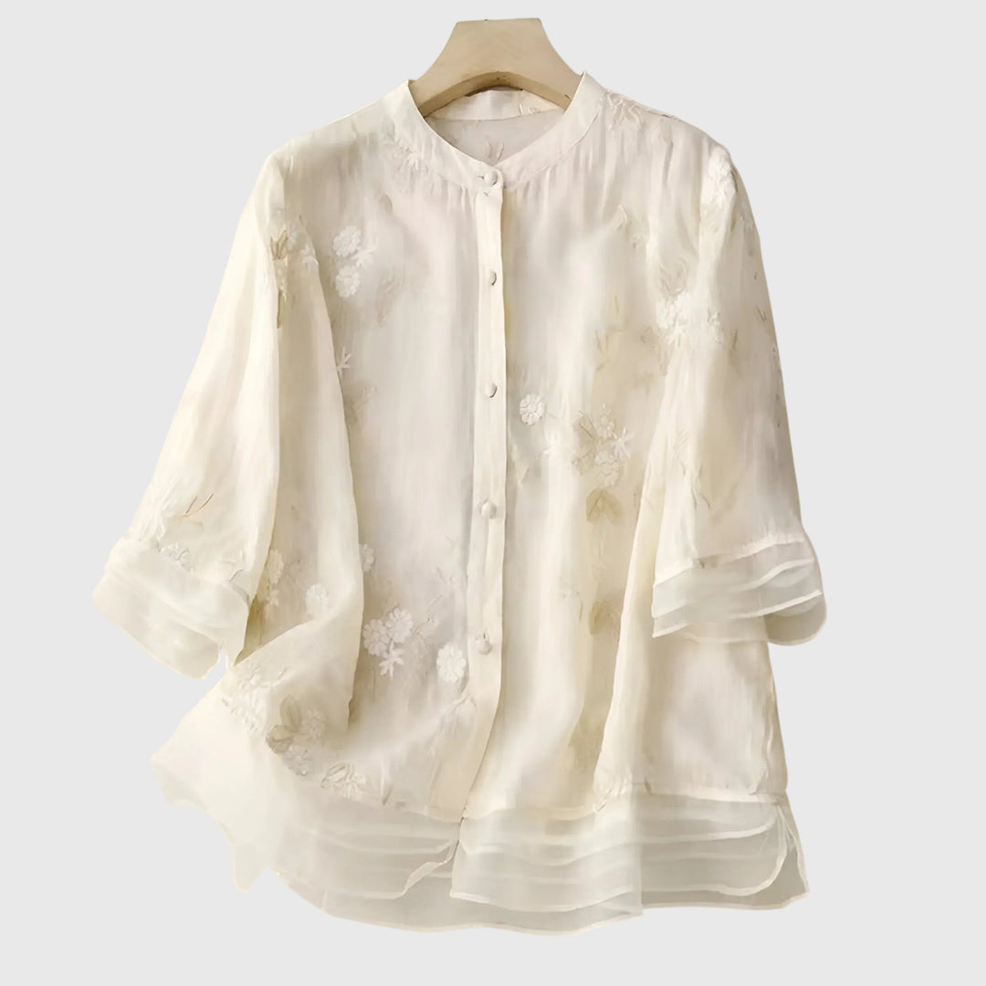 Elegant women's blouse with intricate floral embroidery, perfect for special occasions & versatile spring-summer style.