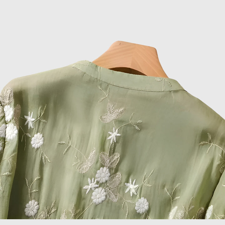 Stylish women's spring-summer blouse featuring vibrant floral embroidery & an elegant, relaxed fit design.