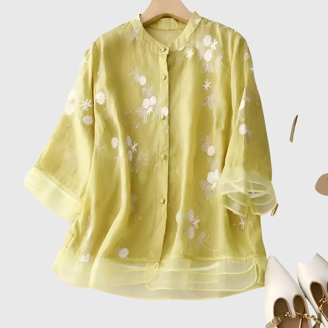Bohemian chic women's blouse, featuring elegant floral embroidery and a comfortable relaxed fit for summer style.