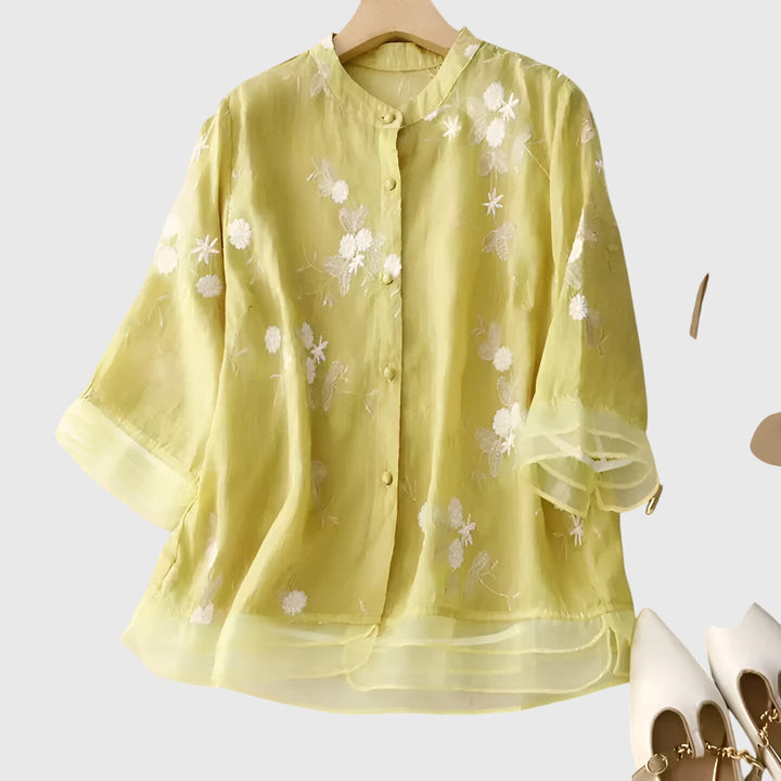 Bohemian chic women's blouse, featuring elegant floral embroidery and a comfortable relaxed fit for summer style.