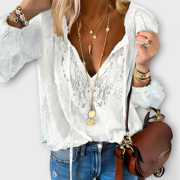Elegant women's bohemian blouse with a stylish tie neck and long sleeves, perfect for sophisticated casual chic.