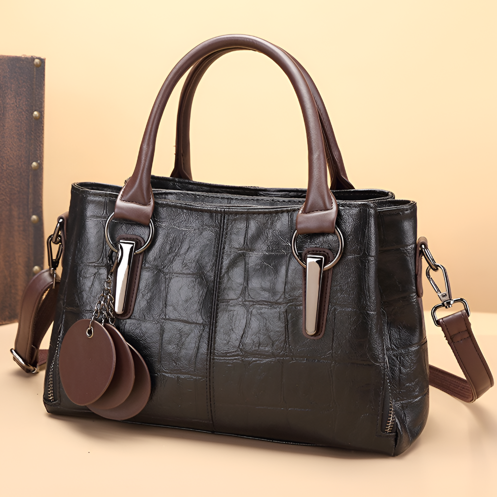 Versatile women's Boston bag featuring croc-embossed leather, a top handle, and a shoulder strap.