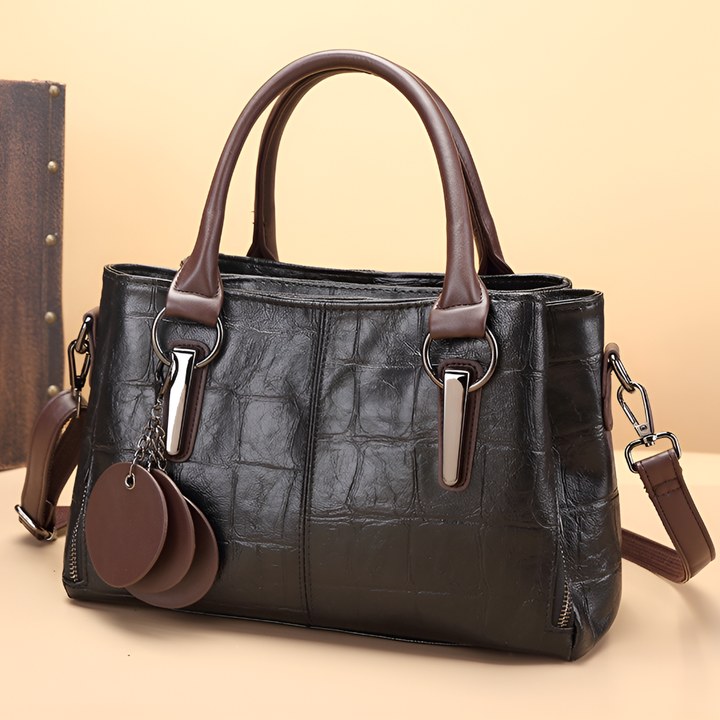 Versatile women's Boston bag featuring croc-embossed leather, a top handle, and a shoulder strap.