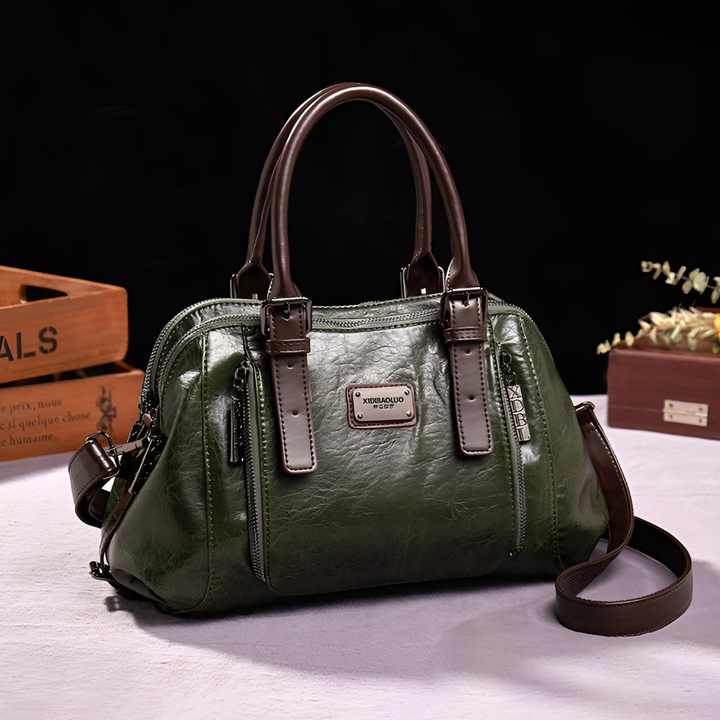 Close-up of a women's croc-embossed Boston handbag, highlighting the texture and elegant finish.
