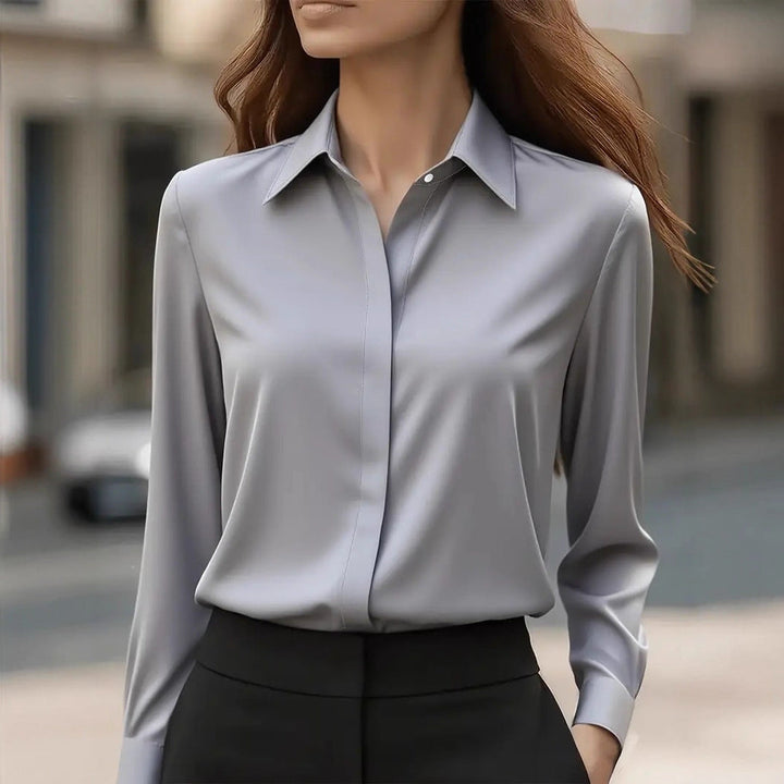 Classic women's button-front blouse, long sleeve and elegant, suitable for versatile office wear.