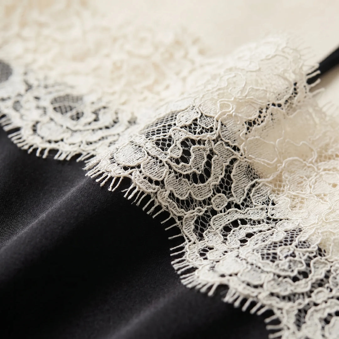 Chic women's camisole top with fine lace trim, a soft, comfortable sleeveless layering piece.