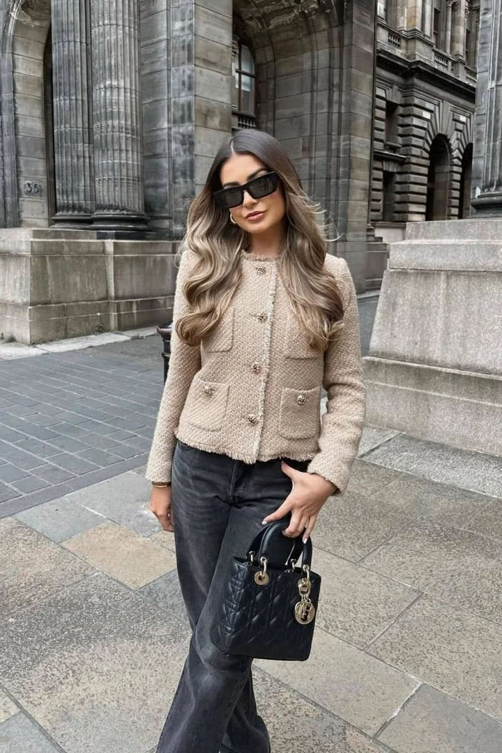 Chic women's cropped blazer with buttons, styled for a sophisticated evening out or special event.