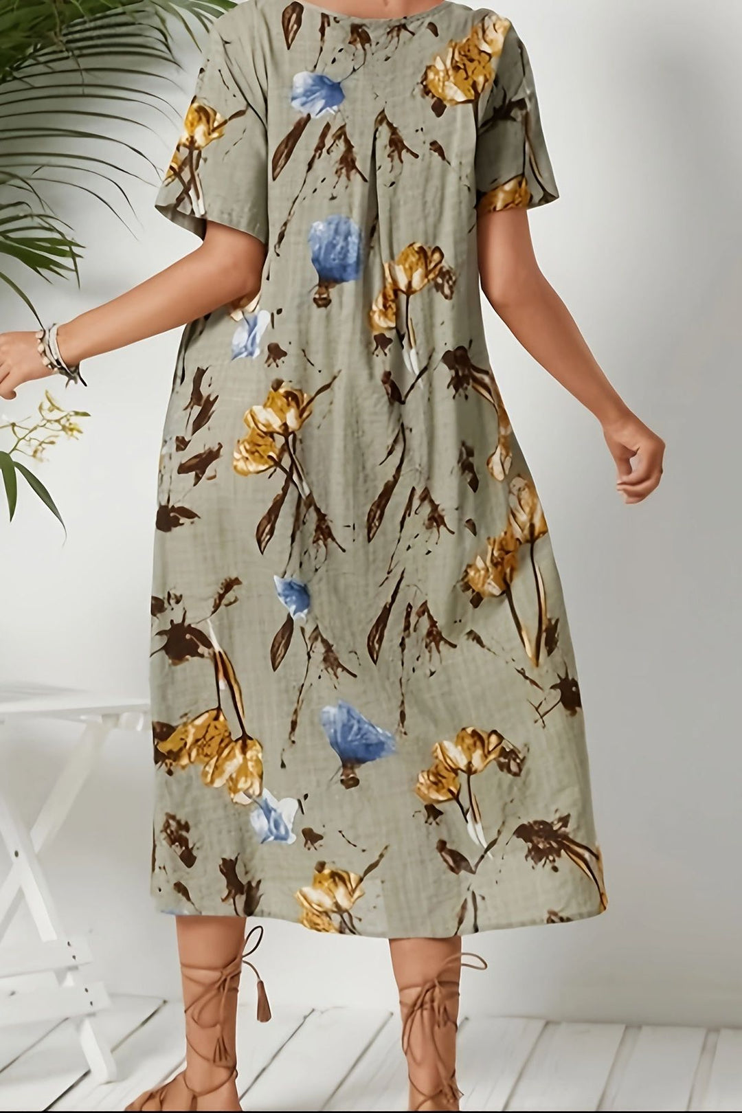 Stylish women's floral midi day dress in dark khaki, featuring a flattering defined waist for spring/summer fashion.